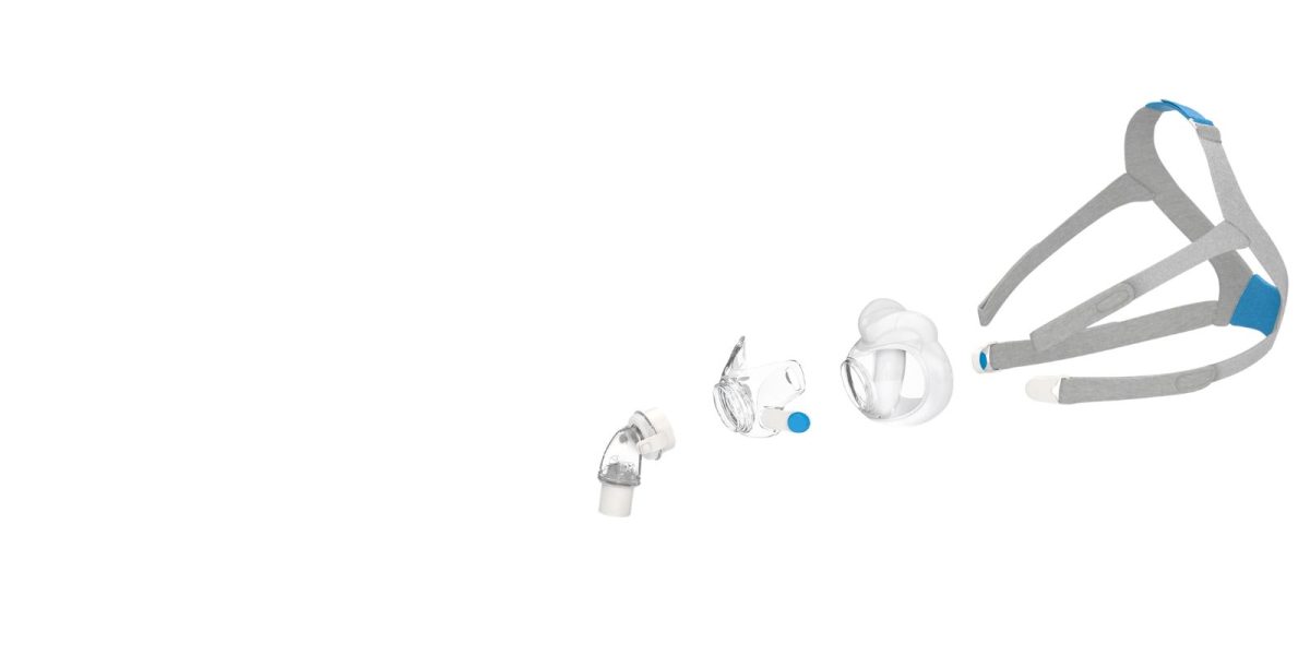 Disassembled CPAP nasal mask showing headgear, cushion, frame, and elbow components