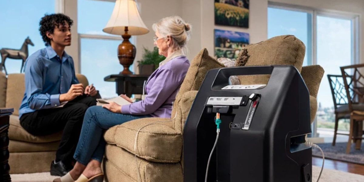 Woman using a home oxygen concentrator while speaking with a healthcare professional