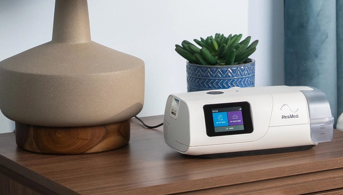 ResMed AirCurve 11 VAuto bilevel therapy machine on a bedside table